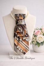 Load image into Gallery viewer, Brown and Gold Striped Statement Necktie Necklace with Crown Brooch and Pearl Drop Accents
