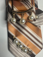 Load image into Gallery viewer, Brown and Gold Striped Statement Necktie Necklace with Crown Brooch and Pearl Drop Accents

